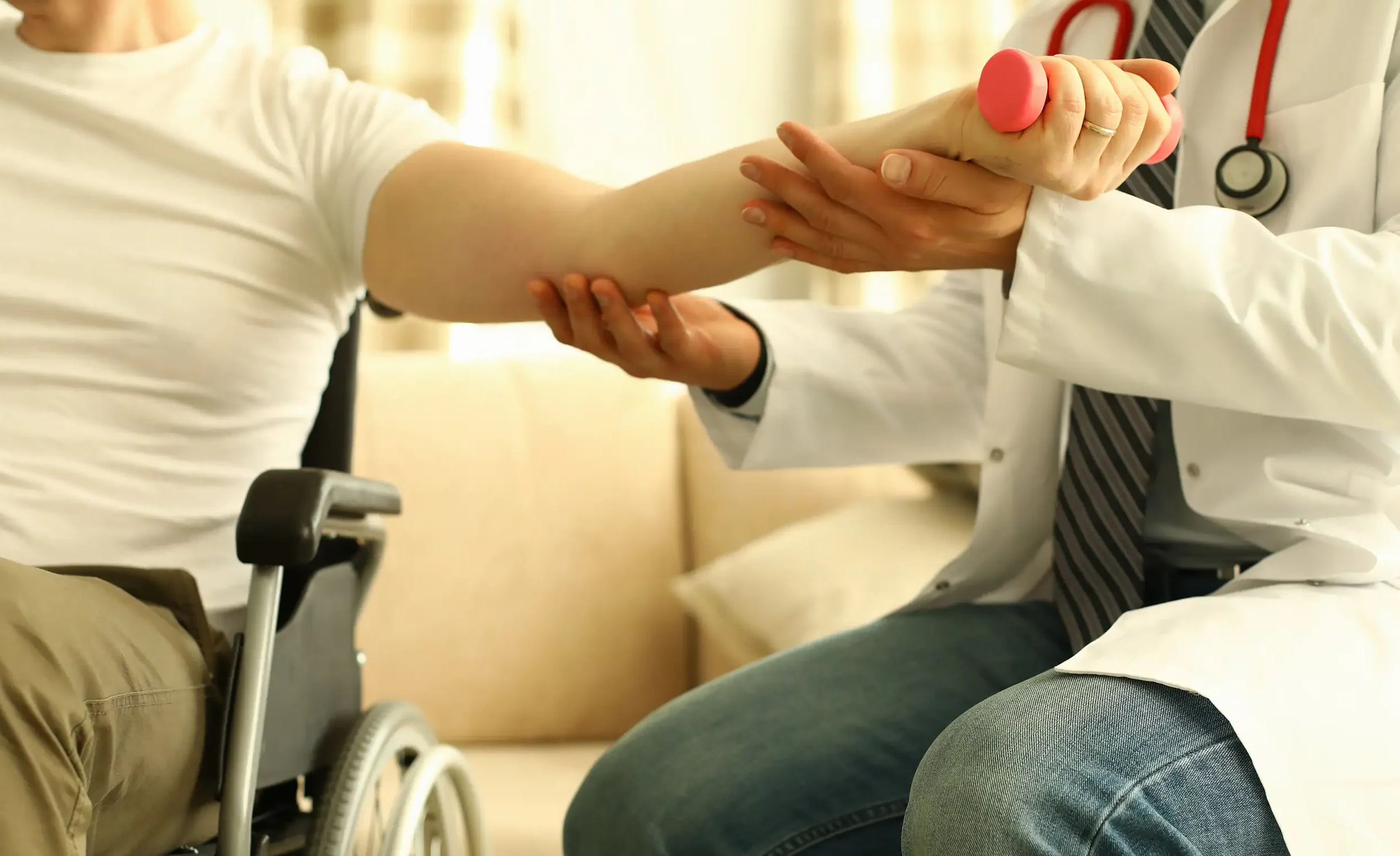 Professional orthopedic doctor helping patient through occupational therapy exercises for pain relief - Central Illinois